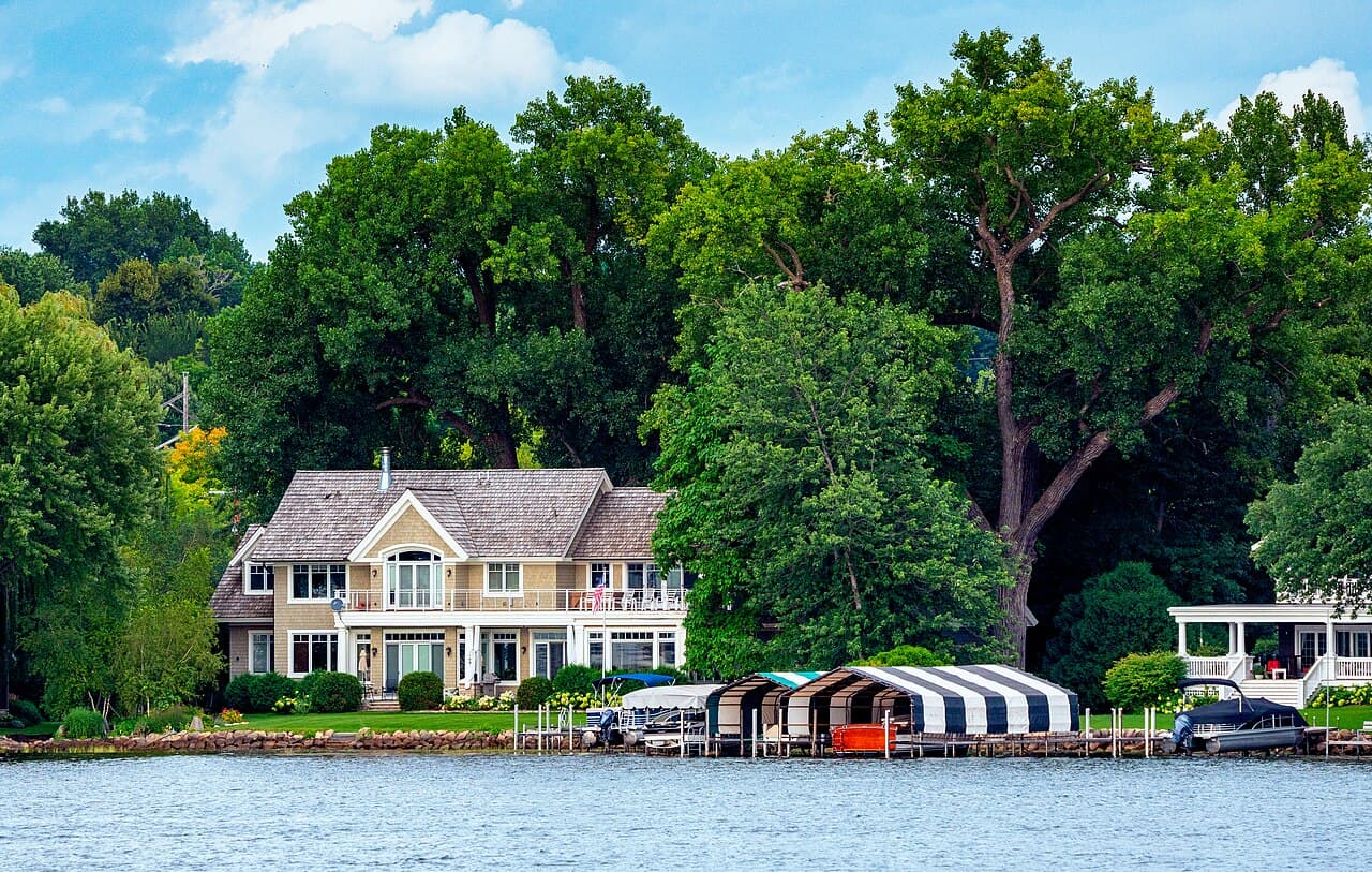 Lakefront home with private boat docks and covered boat slips along the shoreline of Lake Minnetonka in Excelsior, Minnesota